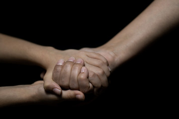 Mother and daughter holding hands. Helping hands.