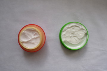 Cream for the body and face on a white background. The view from the top.
