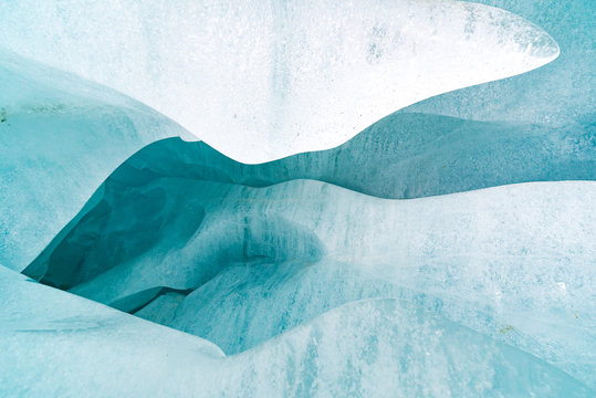 Breaking ice in glacier, ice wall texture taken from a natural glacier cave in Zinal, Switzerland 
