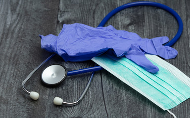 Stethoscope, Gloves and Mask on Wood Table