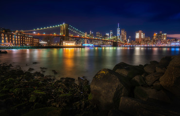 Naklejka na ściany i meble Famous Skyline of downtown New York, Brooklyn Bridge and Manhattan at Night , New York City USA .