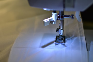 Sewing machine work, sewing the tape to the curtain.