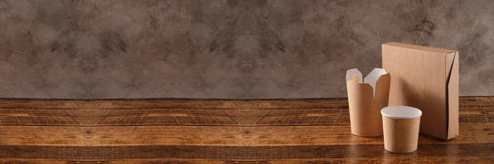 Street fast food paper cups, plates and containers. Eco-friendly food packaging on wooden background. Carering of nature and recycling concept. Banner.