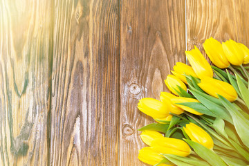 mother's day concept. tulips flower on dark wooden background