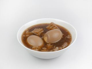 Egg and Pork in Sweet Brown Sauce(Khai Palo)Egg  on white background, stewed eggs in brown sauce by Thai food