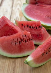 Fresh ripe sliced watermelon on wooden rustic background