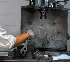 Mechanic is repairing equipment in the factory.