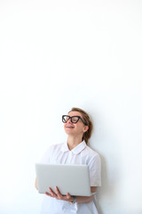 girl works at home standing near a white wall