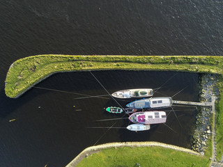 Aerial top view small boats and yachts in a harbor. Five vessels.