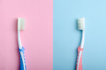 toothbrushes in love or upset on pastel colors as a man and woman