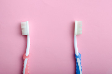 toothbrushes in love or upset on pastel colors as a man and woman