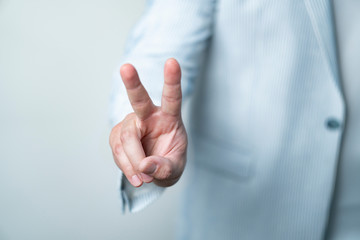 businessman showing victory gesture