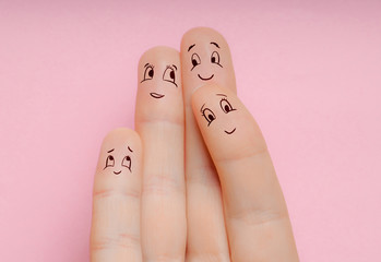 concept of four fingers as a man woman and children hug together and love each other