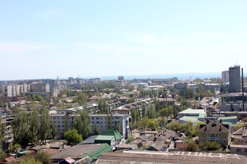 View of the city from above, the sea in the distance. City and sea on the horizon. Open space.