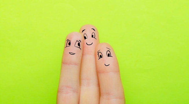 the concept of three fingers as a man a woman and a child hug together and love each other