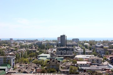 View of the city from above, the sea in the distance. City and sea on the horizon. Open space.