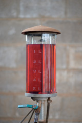 An old, manually pumped petrol (gas) pump on a small, remote island in Thailand