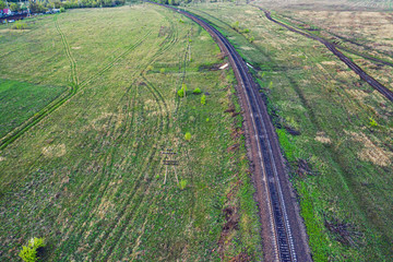 Fototapeta na wymiar Aerial photo from a drone flying along a train track in a rural