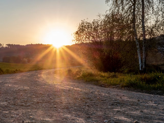 A dirt road on the border of a lake in Switzerland in Spring at sunset