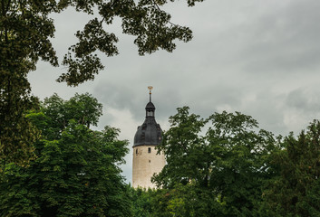 View of the tower of Altenburg castle against a cloudy sky. Germany. Soft focus, blurry background.