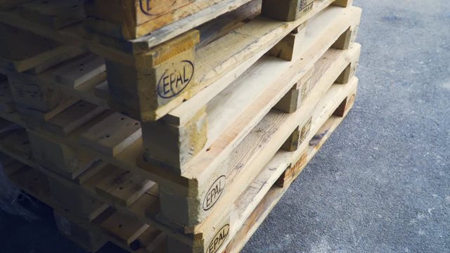 Industrial transportation, European standard EPAL pallets outside factory, close up shot.