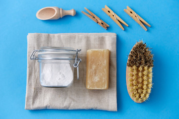 cleaning stuff, sustainability and eco living concept - natural brush, washing soda in glass jar...