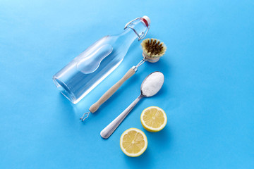 natural cleaning stuff, sustainability and eco living concept - lemon halves, washing soda, bottle...