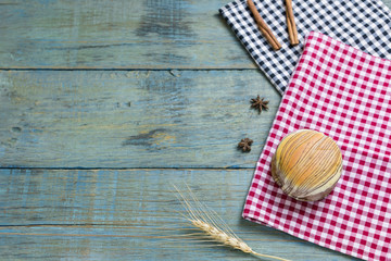 fresh bread put on red.scottish pattern fabric with grains on old wooden table background.Top view with copy space and selective focus.