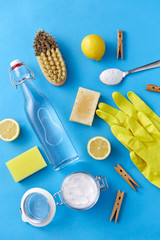 natural cleaning stuff and eco living concept - bottle of vinegar, lemons, rubber gloves, washing...