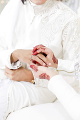 Obraz na płótnie Canvas a bride put on a wedding ring to the groom