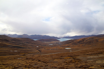 Brown mountains, blue lakes, changing clouds, a beautiful plateau scenery