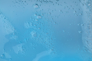 Sample of light blue cosmetic gel as background, closeup