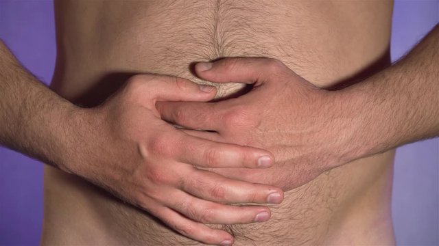 Close up of man touching his hairy belly with his hands. Concept of healthy food and lifestyle. Human body without clothes