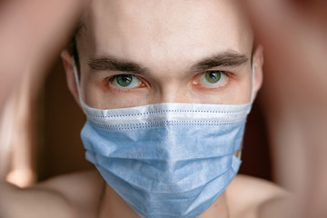 guy in medical mask on quarantine self-isolation