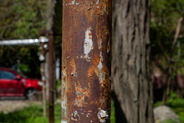old rusty pillar stands on the street
