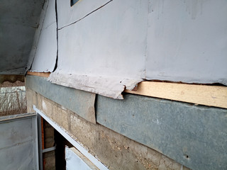 Fototapeta na wymiar Repair of pediment of the house. Steel pediment on the garage. Roof repair.