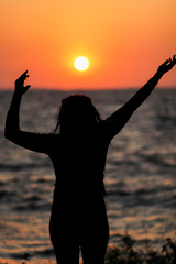 Fototapeta premium silhouette of a woman in the sunset