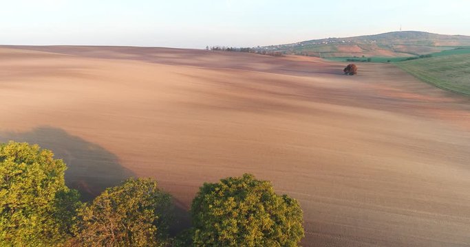 Wide angle dolly in drone shot of dry land in the eastern part of the Czech Republic in Moravia during the day