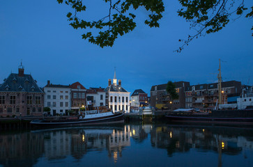 City of Schiedam at night. Twilight. Harbour and boats.