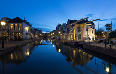 Fototapeta na wymiar City of Schiedam at night. Twilight. Draw bridge and canal