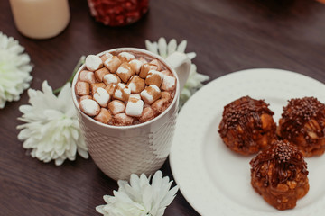 cake anthill on a plate on the table, cocoa with marshmallow in a white mug, home comfort