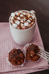 cake anthill on a plate on the table, cocoa with marshmallow in a white mug, home comfort