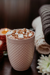cocoa with marshmallow in a white mug on the table, home comfort
