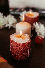 aroma candles on the table, knitted clothes and home comfort