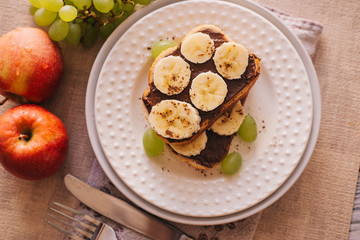 chocolate paste toast with banana for Breakfast, fruit