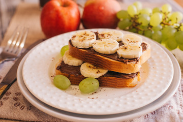 Obraz na płótnie Canvas chocolate paste toast with banana for Breakfast, fruit