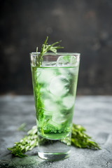 Sweet tequila based green cocktail with tarragon and rosemary. Selective focus. Shallow depth of field.