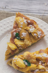 Apple pie for Breakfast on a white plate, wooden background