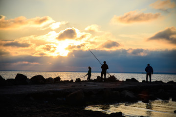 
man with woman fishing at sunset