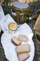 bread, military flask, iron mug lie on a white towel